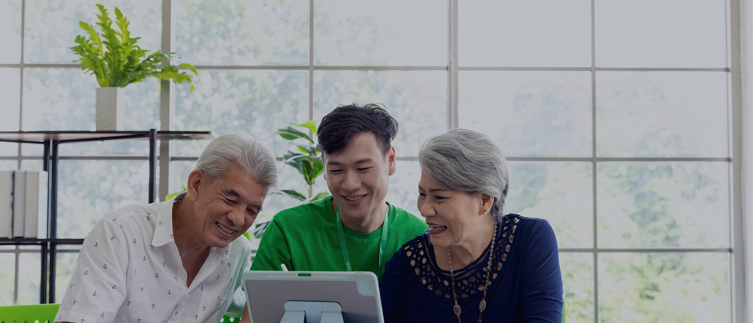 An older couple going through plan options with an agent at a bright kitchen table